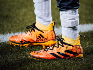 Bright pair of orange and yellow adidas cleats