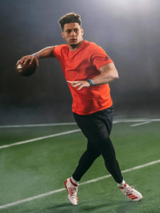 1UP Sports Marketing client Patrick Mahomes about the throw the football during a video shoot