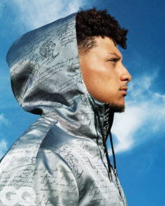 Side shot of 1UP Sports Marketing client Patrick Mahomes wearing a silver hoodie for a GQ photoshoot