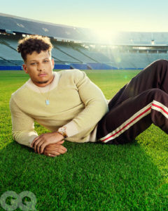 1UP Sports Marketing client Patrick Mahomes lies on his side while wearing a sweater and sweatpants for a GQ photoshoot