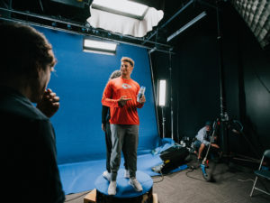 1UP Sports Marketing client Patrick Mahomes smiling and pointing at a shampoo bottle during a Head & Shoulders commercial