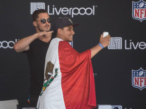 1UP Sports Marketing clients Danny Amendola posing for a selfie with a Mexican fan wearing the Mexican flag