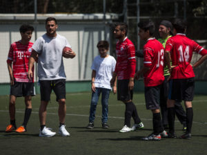 1UP Sports Marketing clients Danny Amendola in Mexico with young athletes