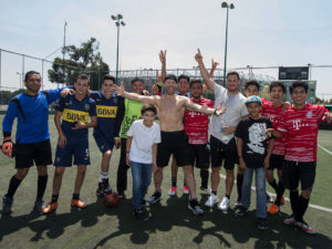 1UP Sports Marketing clients Danny Amendola and Julian Edelman in Mexico posing for a photo with soccer players