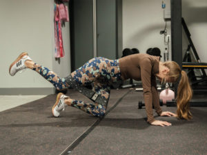 Expectant mom and 1UP Sports Marketing client Brittany Lynne Matthews working out with a resistance band