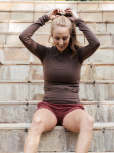1UP Sports Marketing client Brittany Lynne Matthews outside sitting on stairs while preparing for a run