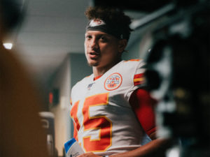 1UP Sports Marketing client Patrick Mahomes standing in the locker room during the filming of a Head & Shoulders commercials